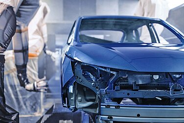 Blue vehicle body in a paint shop.
