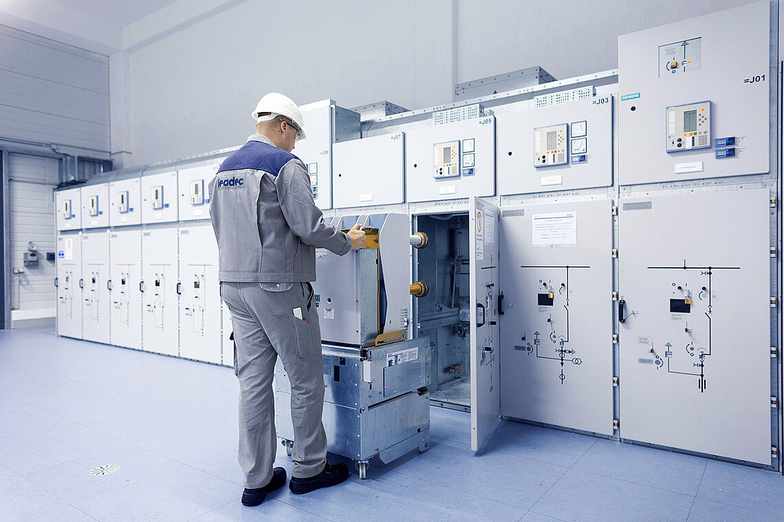 A Leadec employee installing a switchgear in a technical room.