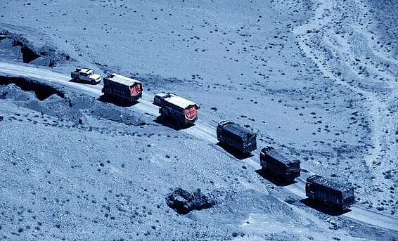 Convoy of trucks driving in the desert.
