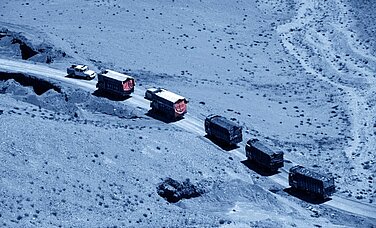Convoy of trucks driving in the desert.