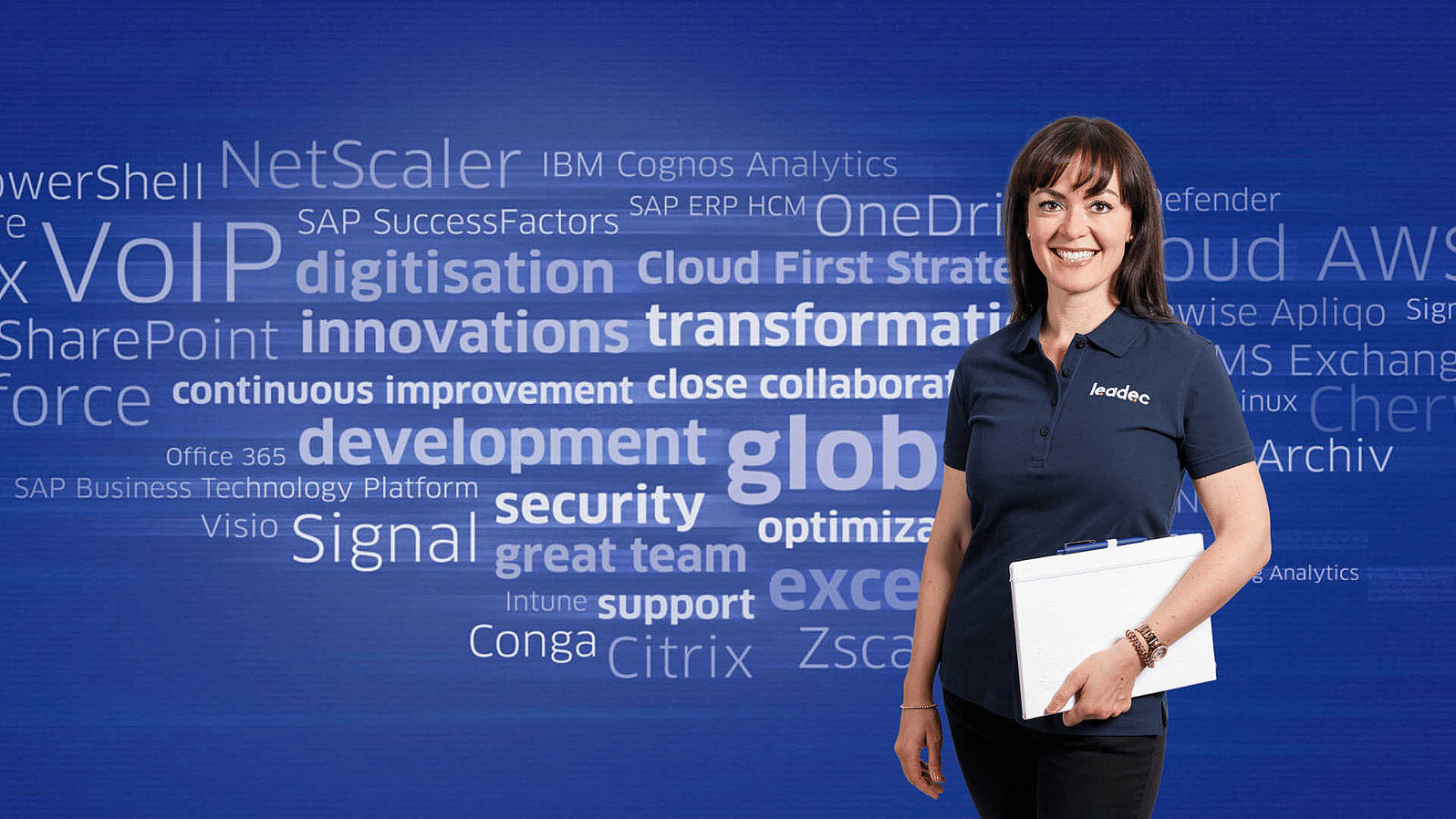 Female Leadec employee with notebook in front of a digital word cloud with terms from the IT sector.