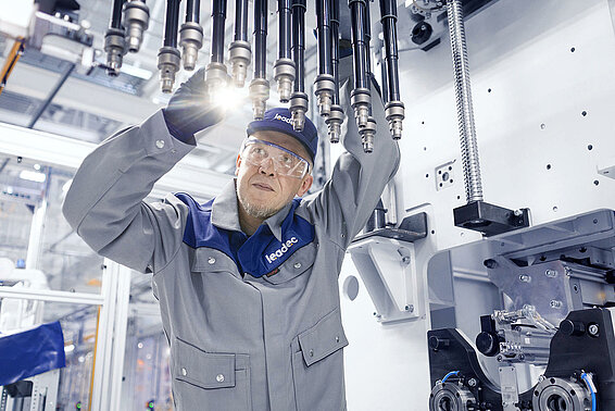A Leadec employee maintaining a facility in a production area.